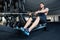 Fitness man using rowing machine at gym