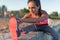 Fitness model athlete girl warm up stretching her hamstrings, leg and back. Young woman exercising with headphones