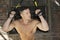 Fitness model workout his triceps with trx straps