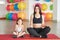 Fitness mother and child. Sports activities with children. Fitness center. Mom and baby gymnastics, yoga exercises. Health and