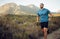 Fitness, mountain and man running in nature training for health, wellness and sports workout. Exercise, lifestyle and