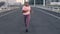 Fitness, music and plus size woman running in road for wellness, health and cardio in city. Black woman, run and weight