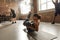 Fitness is my Outlook. Athletic young woman using a ball while having workout on a mat at industrial gym. Group training