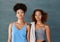 Fitness is our main focus. Studio portrait of two young women after yoga class against a grey background.