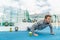 Fitness outdoor gym man training pushups workout in sportswear with green smoothie. Athlete working out strength