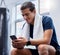 Fitness, phone and man relax in gym tracking workout, exercise or progress on app. Tech, sports and happy male with