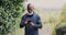 Fitness, phone and a senior sports black man checking his progress while outdoor in nature for a run. Exercise, app and