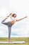 Fitness, pilates stretching and woman in park for outdoor wellness, mindfulness and healthy lifestyle with clouds sky