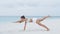 Fitness plank exercise - woman exercising on beach living healthy lifestyle.