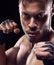 Fitness, portrait and man boxer in studio for power, resilience and training on black background. Fighter, hands by face