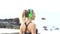 Fitness pretty blonde woman on tropical beach during beautiful summer day