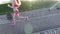 Fitness routine for women - athletic girl runner jogging along road wide angle. Slow motion