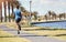 Fitness, running and a man outdoor for exercise, training or cardio health at a park. Back of male athlete on path by