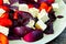 Fitness salad with plums, white cheese and blue basil.