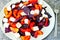 Fitness salad with plums, white cheese and blue basil.