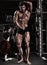 Fitness shaped muscle man posing on dark gym