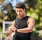 Fitness, smartwatch and sports man listening to music with earphones and gadget while outdoor for exercise, fitness and