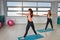 Fitness, sport, exercising lifestyle - Happy women wear in bodysuits doing exercises at gym