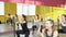 Fitness, sport, training and lifestyle concept - group of women doing pilates exercises squats in fitness studio