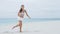 Fitness sport woman strength exercising legs - bodyweight exercise on beach