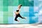 Fitness sport young girl in sportswear doing yoga fitness exercise on a wall background. Sporty gymnast child preteen running