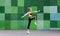 Fitness sport young girl in sportswear doing yoga fitness exercise on a wall background. Sporty gymnast child preteen training