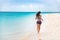Fitness sports athlete woman runner jogging on Caribbean beach vacation destination. Running girl living an active and fit