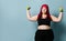 Fitness spring diet weight loss concept. Lucky plus-size girl overweight woman dieting working out with green weights dumbbells