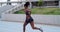 Fitness, stadium and woman running on a track for exercise, endurance or training for competition. Sports, track and