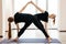 Fitness, stretching practice, group of two attractive women doing symmetric yoga posing