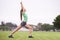 Fitness, stretching and woman on field for exercise, workout and training for running outdoors. Sports, park and person