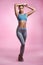 Fitness takes dedication. Full length portrait of an attractive and sporty young woman posing in studio against a pink