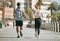 Fitness, teamwork or coaching with a runner couple on the promenade for cardio or endurance from the back. Exercise