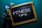 Fitness Tips write on a black board isolated on Office Desk