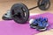 Fitness tools dumbbells yoga mat and shoes on a wooden floor. Healthy living concept
