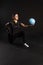 Fitness woman with Aqua ball, holds equipment. Going in for sports on a black background looking at the camera