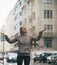 Fitness woman catching rain drops in the city