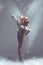 Fitness woman dancer in dust / fog