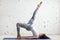 Fitness woman doing one legged bridge pose