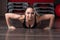 Fitness woman doing push-ups in the gym, close-up