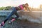 Fitness woman doing push ups Outdoor training workout summer evening. Concept sport healthy lifestyle.