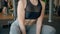 Fitness woman doing squat with dumbbell in hands closeup. female training legs muscle.