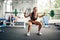 Fitness woman doing squats with barbell