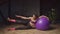 Fitness woman doing stability ball side leg lift