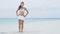 Fitness woman doing standing Side Leg Lift Raise strength training on beach