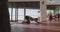 Fitness woman doing stretching in living room