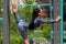 Fitness woman doing a twine outdoors. Athletic girl stretching working out