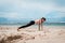 Fitness woman doing yoga exercises. Girl training her abs exercising core muscles with the plank pose.
