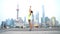 Fitness woman doing yoga in Shanghai city doing sun salutation