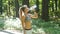 Fitness woman drinking water from bottle in sunny forest